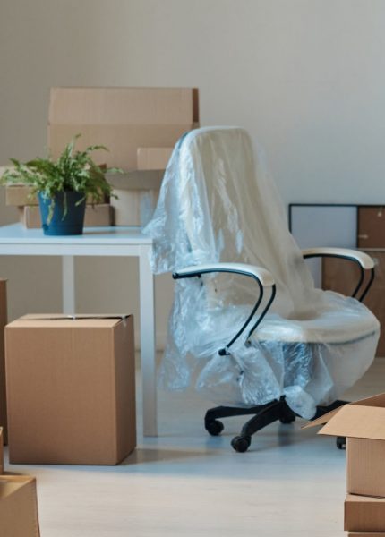 Horizontal image of big light office with new furniture and unpacked cardboard boxes. Credit AnnaStills